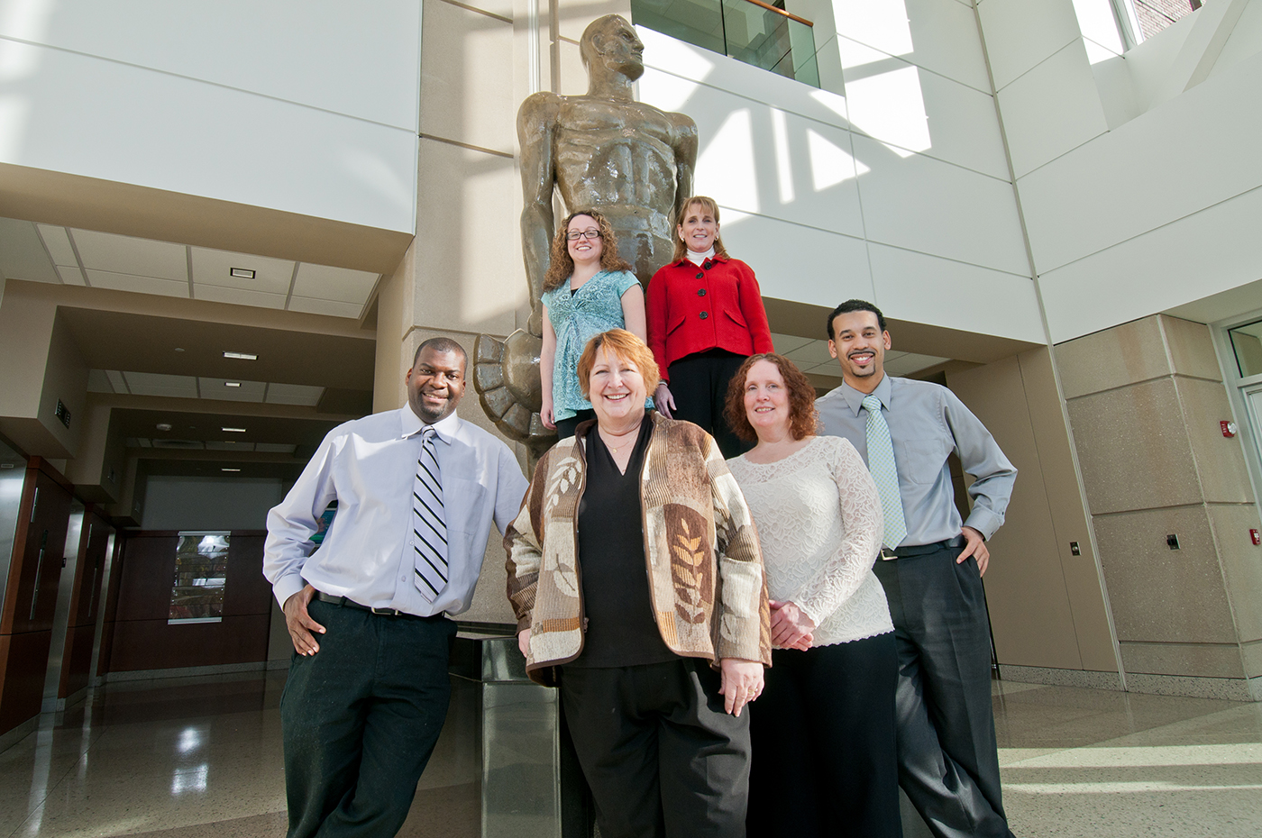 MSU staff standing in front of Sparty Statue
